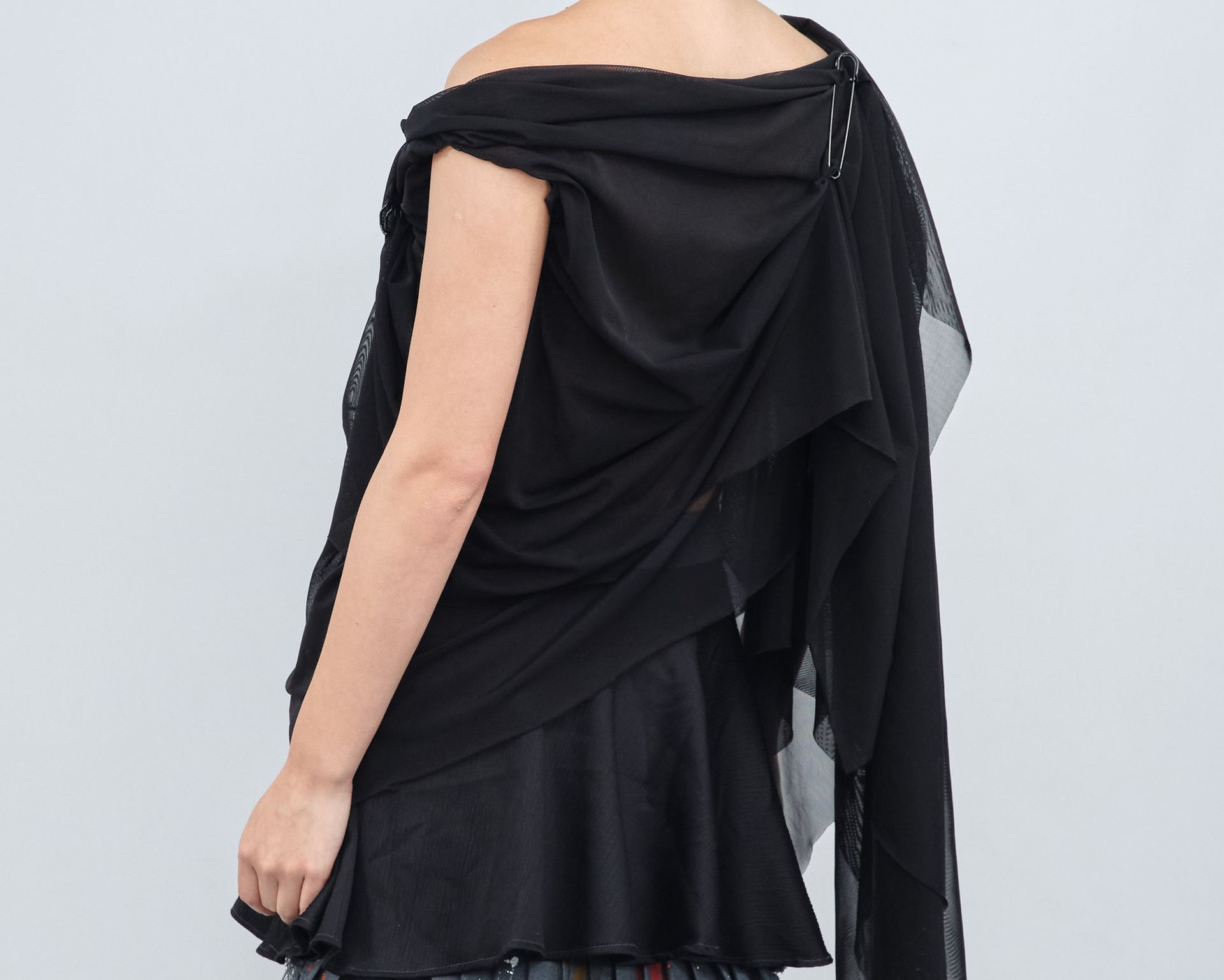 The back of a woman wearing a black shawl
