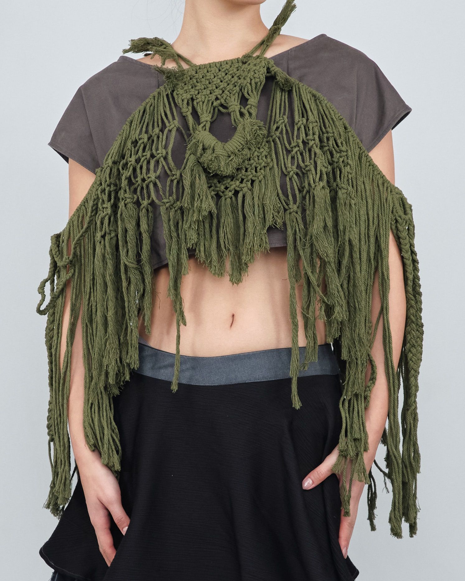 A woman wearing a crocheted scarf around her neck