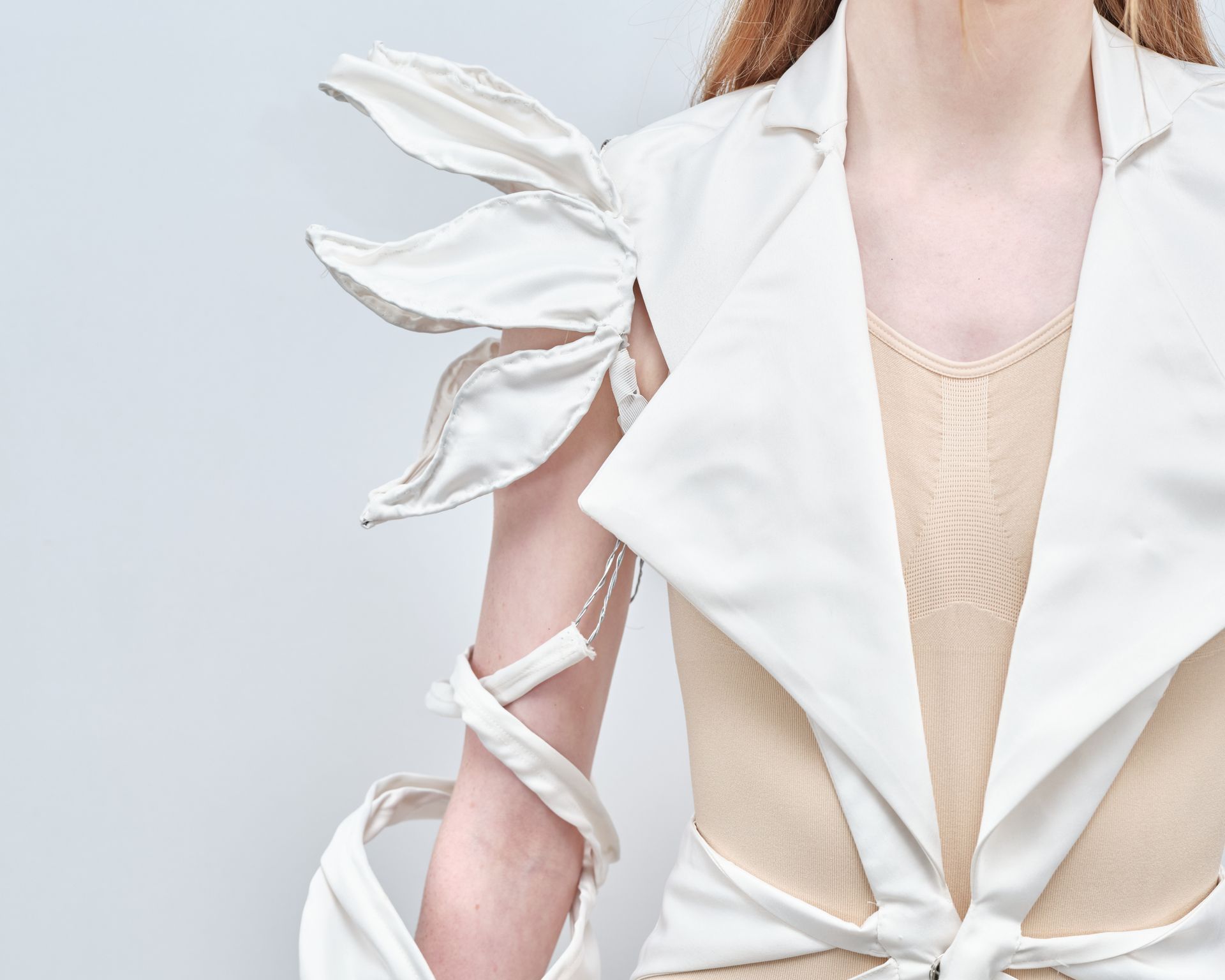 A close up of a woman wearing a white jacket