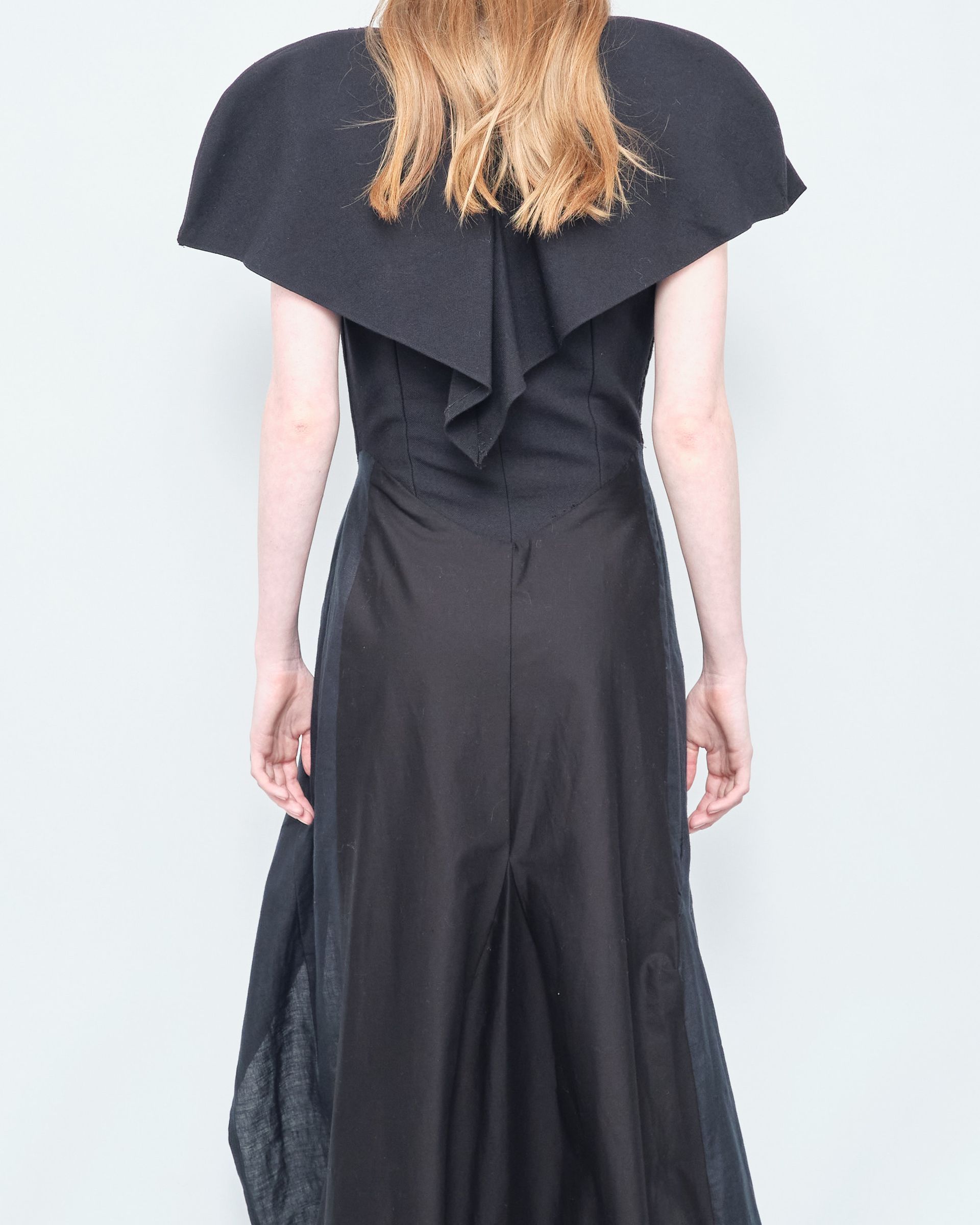 The back of a woman wearing a black dress