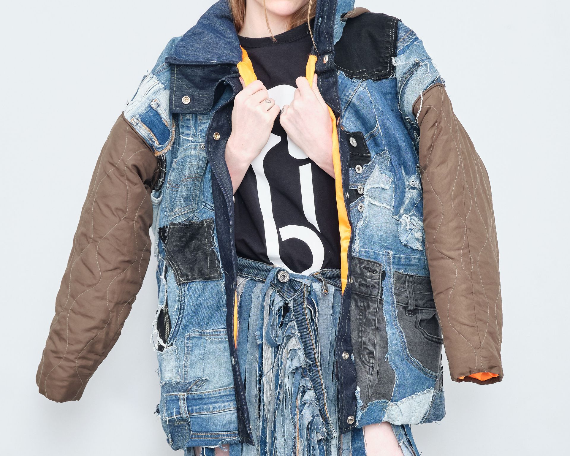 A woman wearing a denim jacket with the number 6 on it