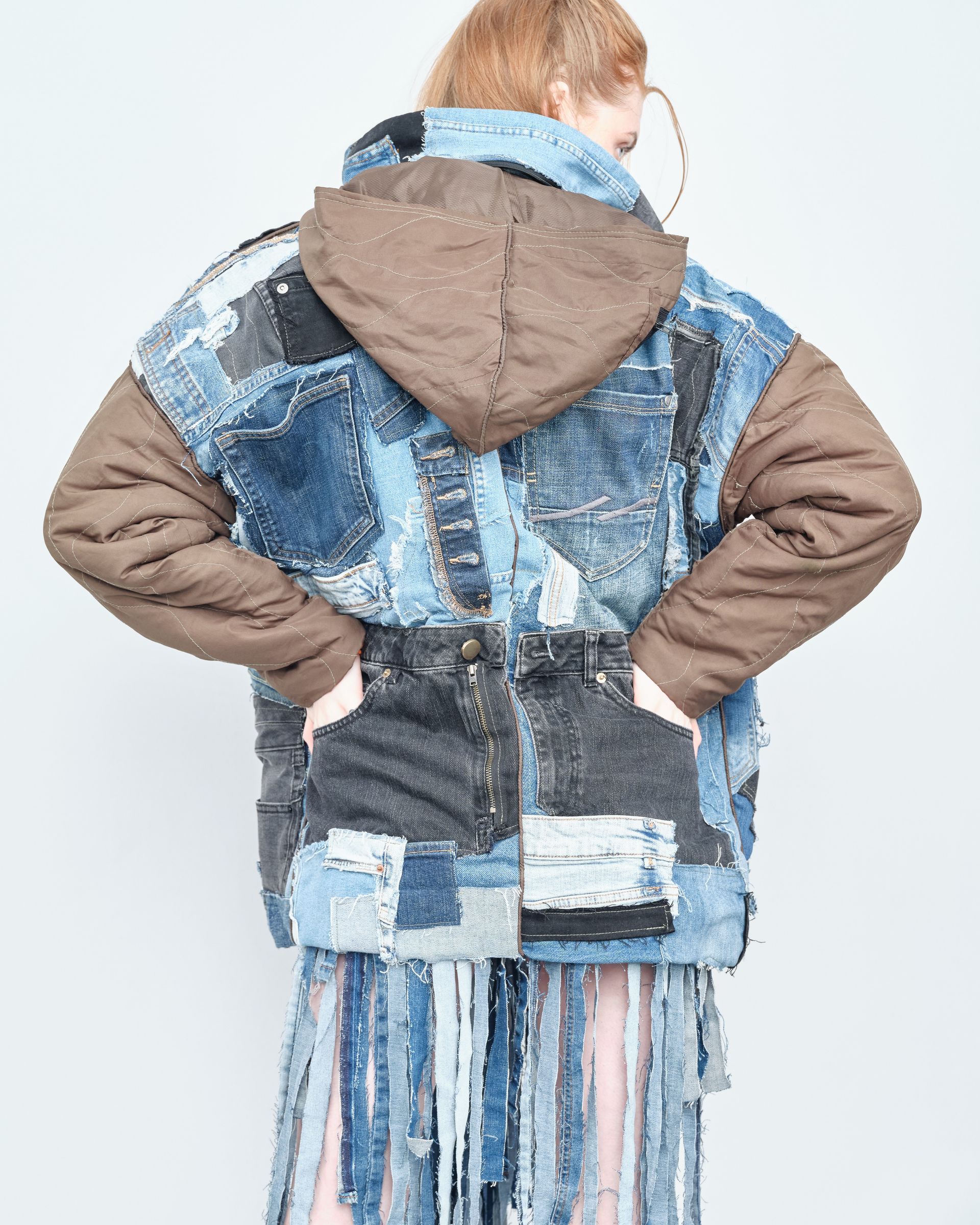 A woman wearing a denim jacket with the number 6 on it