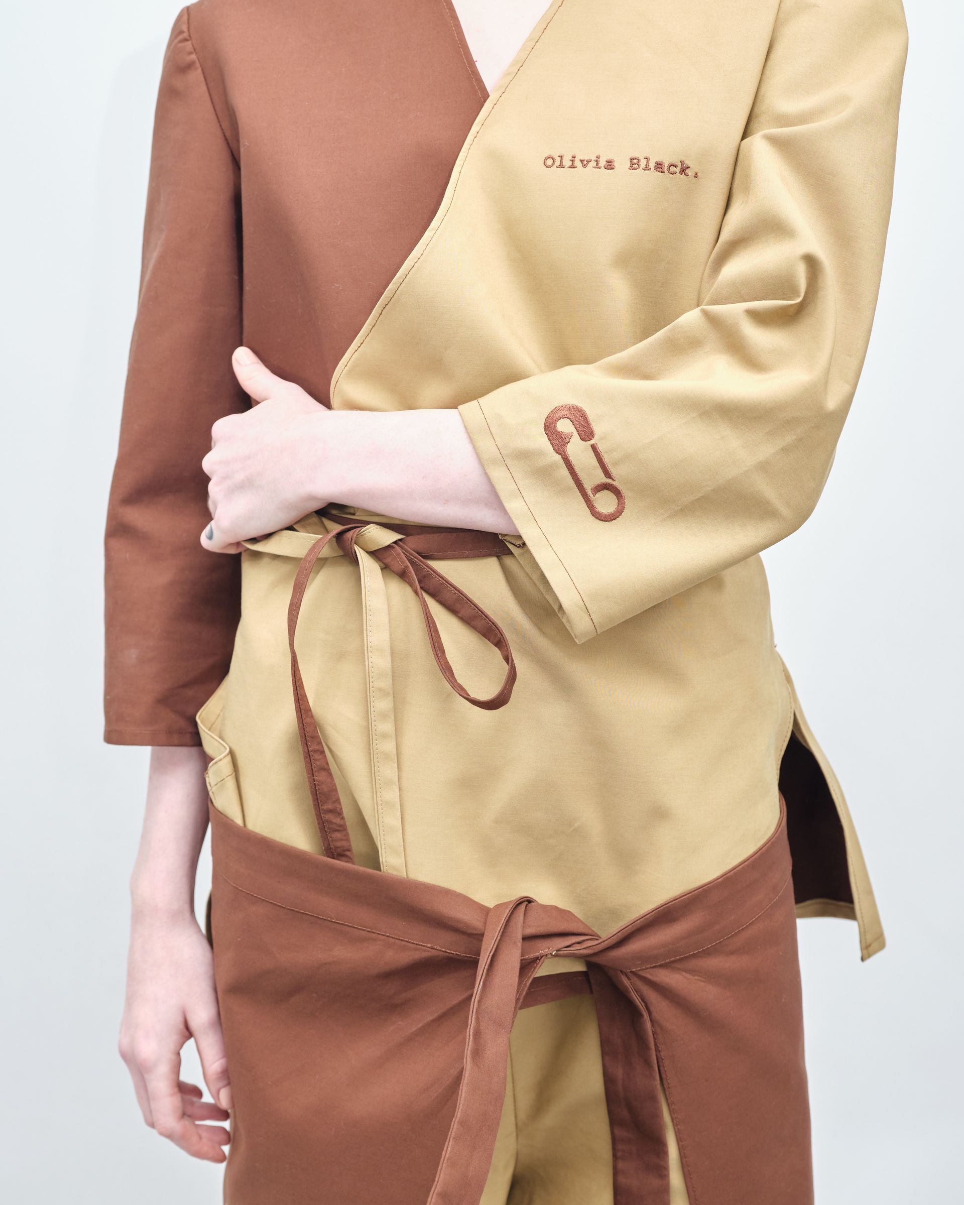 A woman is wearing a brown and tan jumpsuit