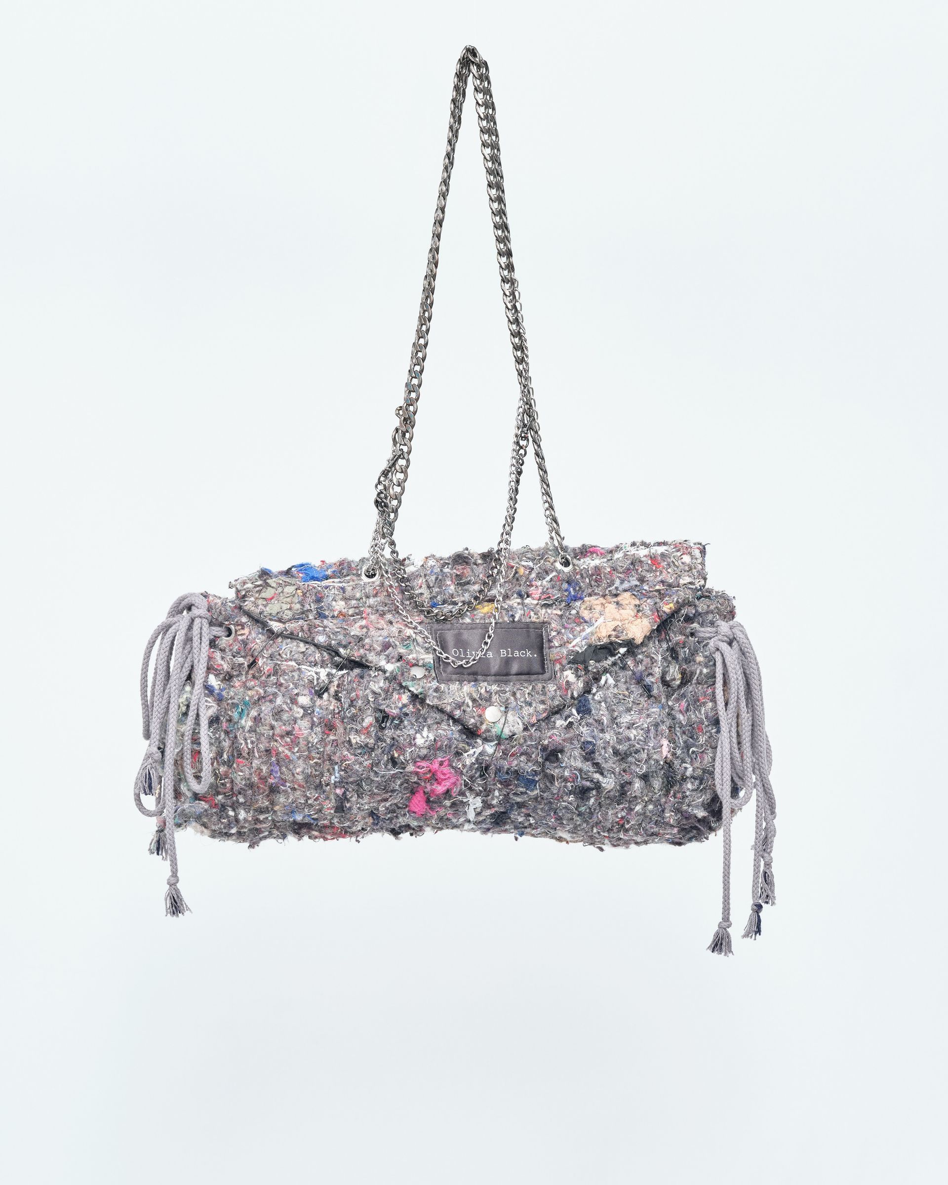 A purse with a chain hanging from it on a white background.