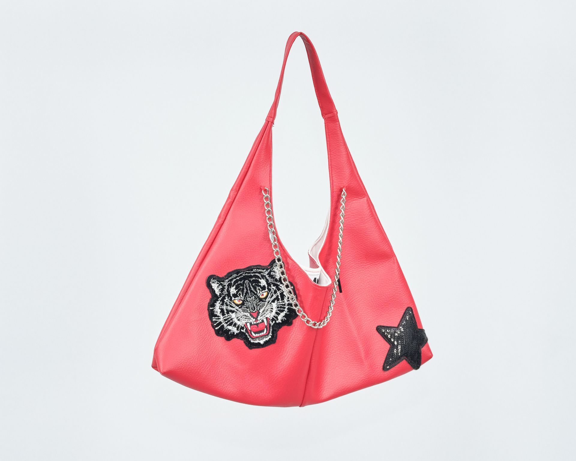 A red purse with a tiger and a star on it