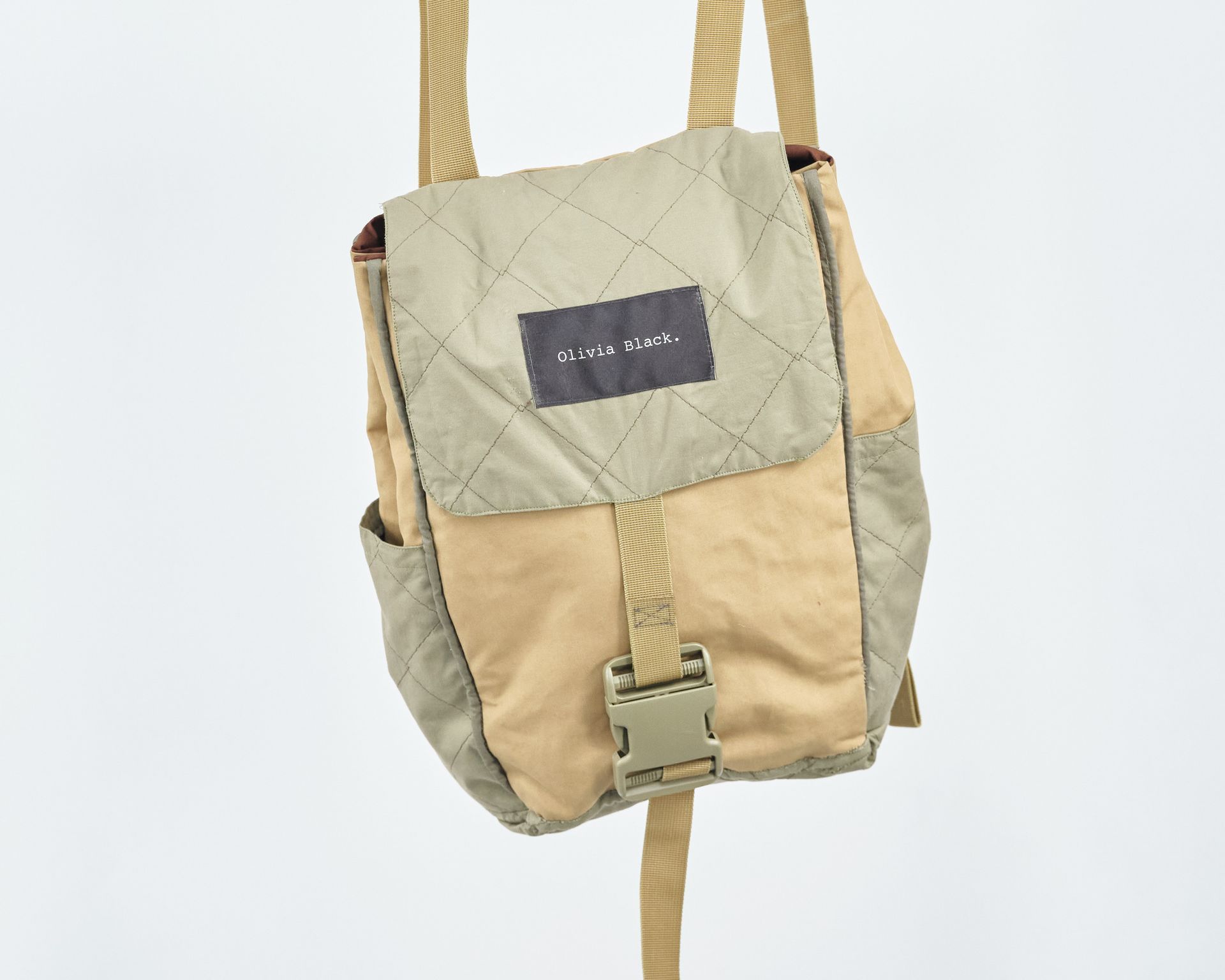 A small tan bag with a buckle on it