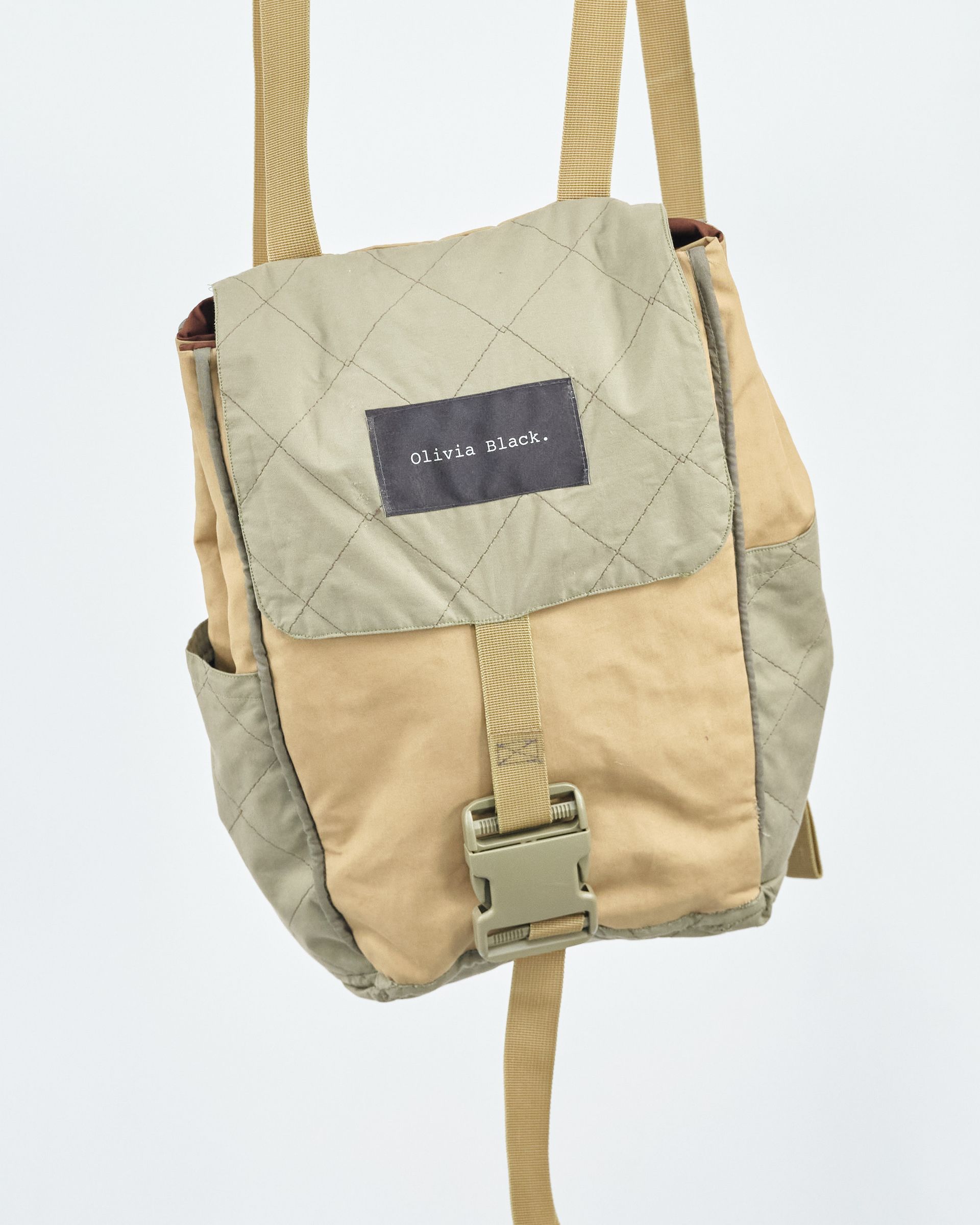 A small tan bag with a buckle on it