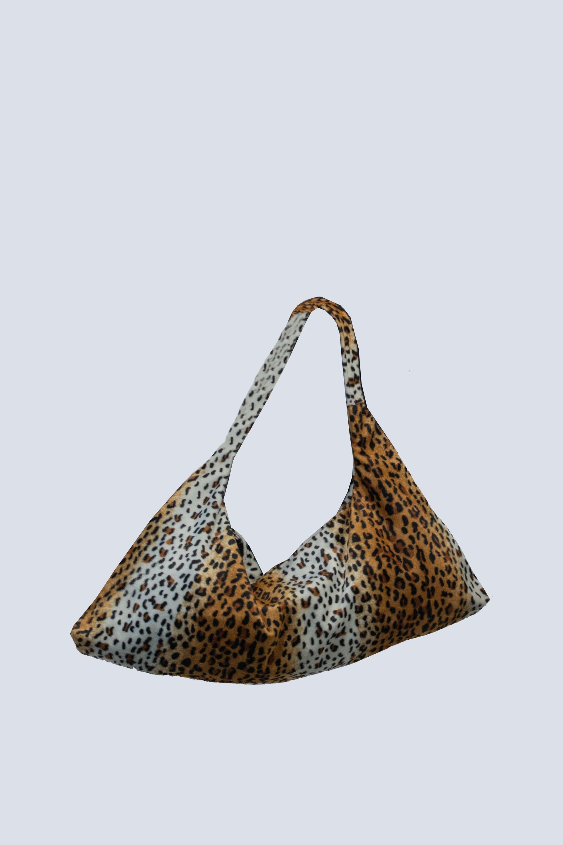A leopard print purse with a long handle