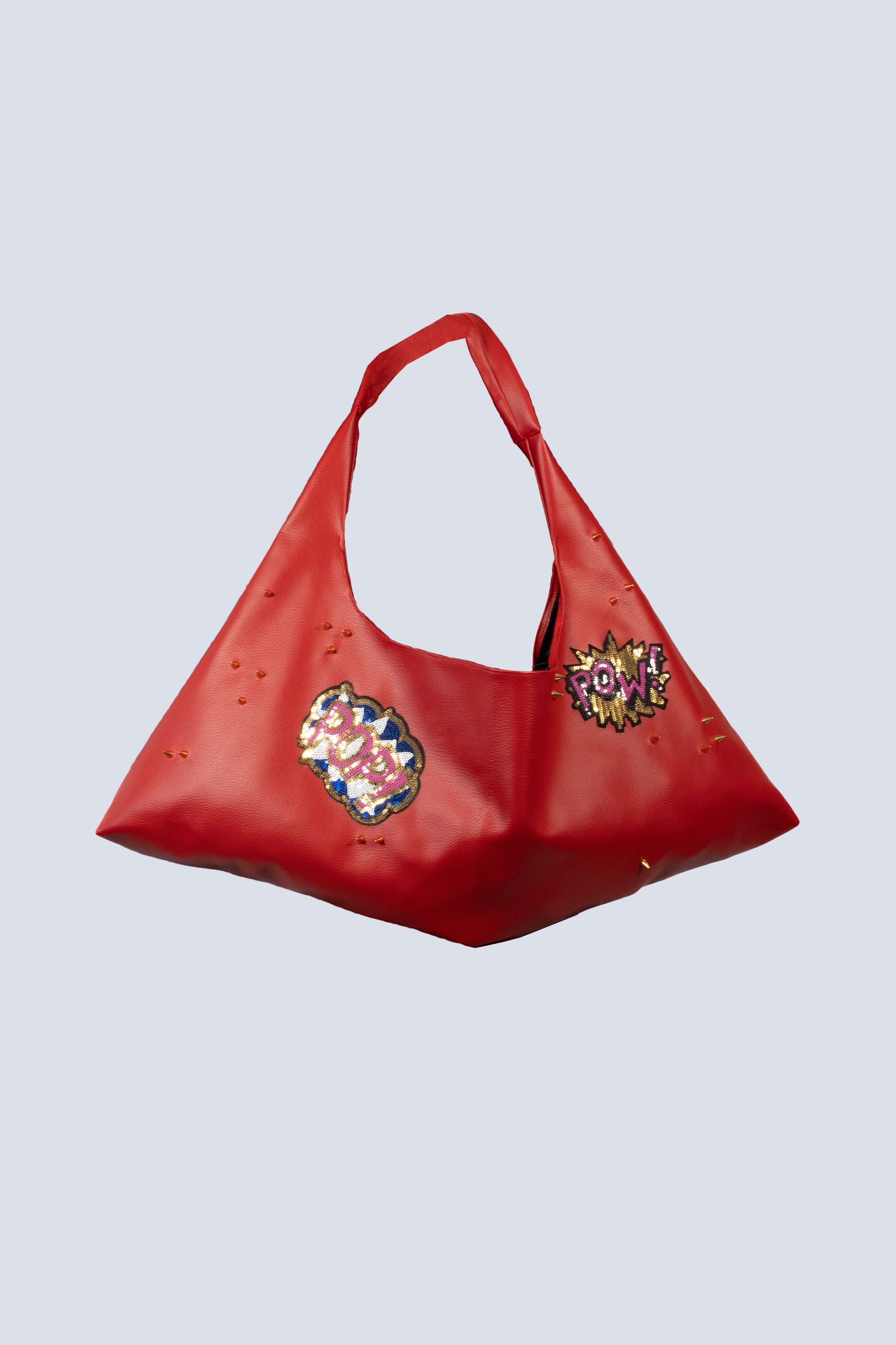 A red purse with two hearts on it on a white background.