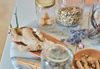 Bread and jars on a table with dried flowers and walnuts