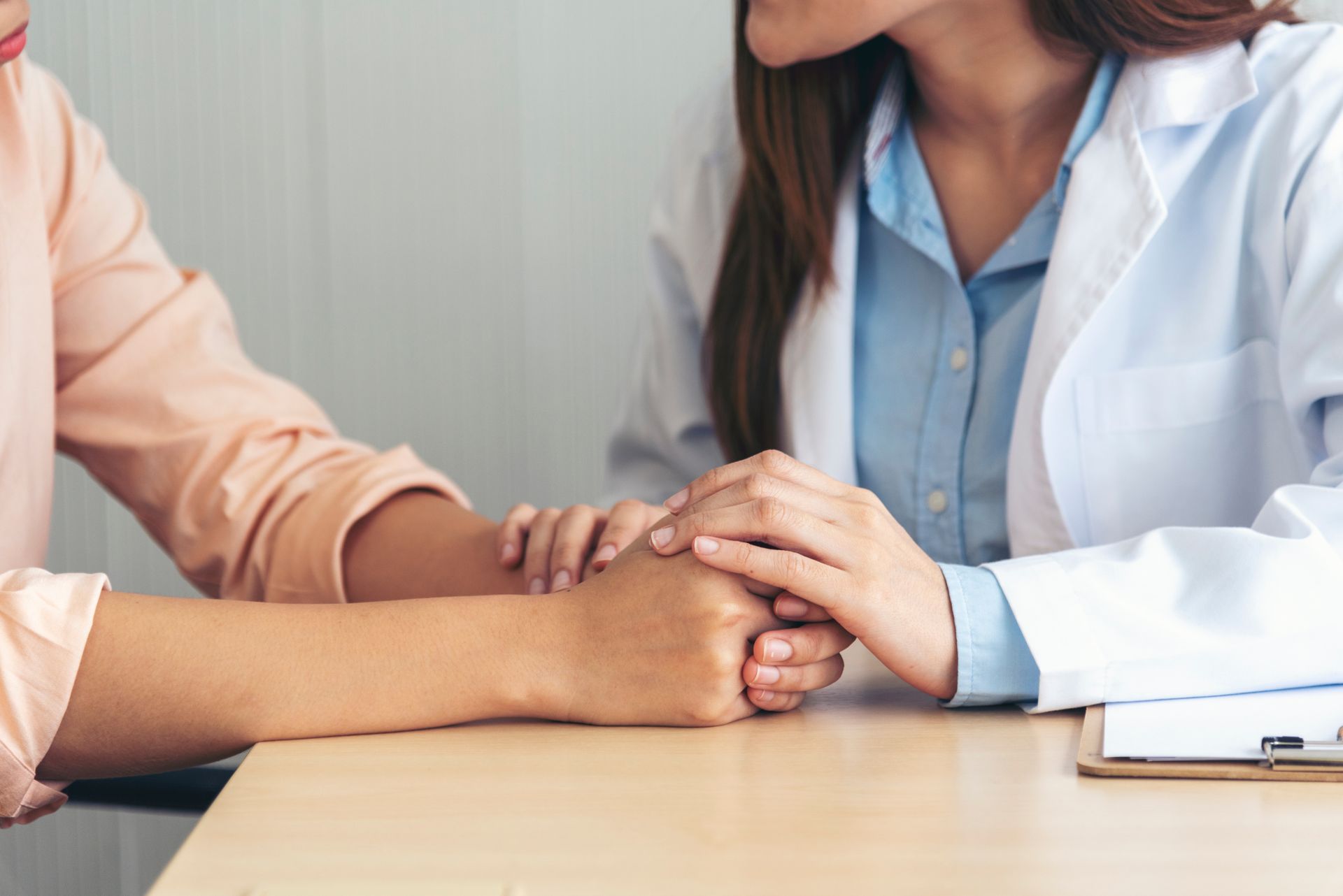 A doctor offering empathy and reassurance during a mental health clinic appointment.