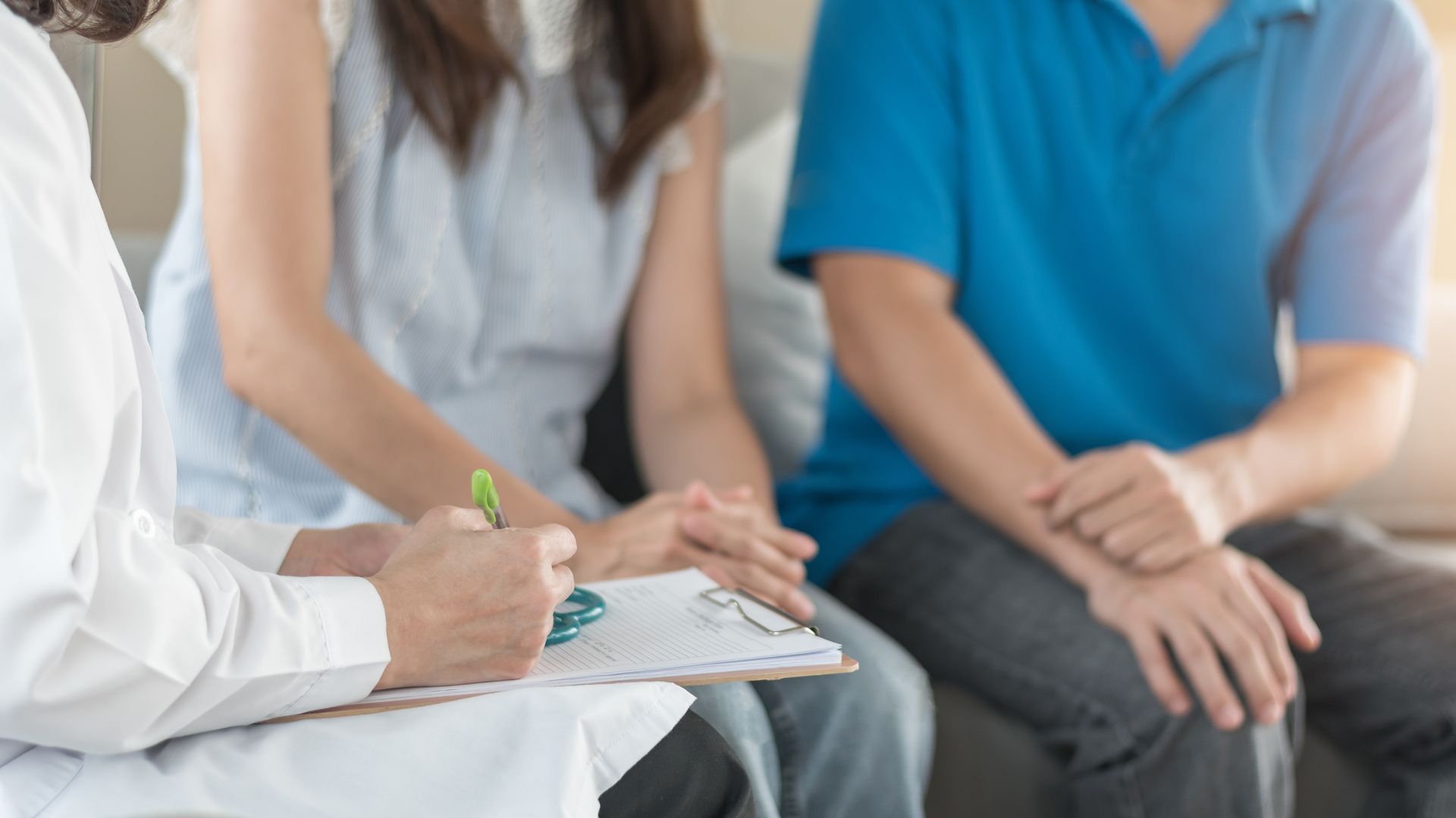 Psychologist offering marriage counseling to couple during a private therapy session.