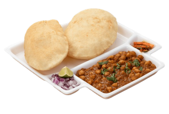 Two puffed bread (puri) with chickpea curry (chole), plus onion, lime and carrot slices, served on a divided white plate.