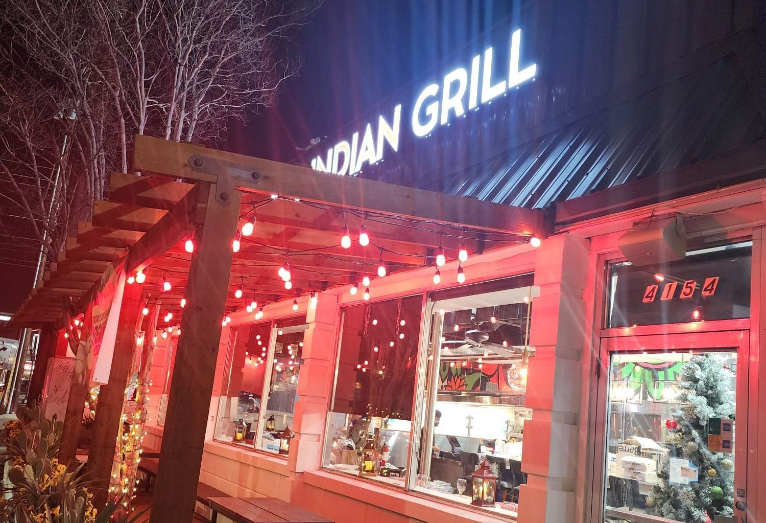 Indian Grill restaurant at night, lit with red lights.