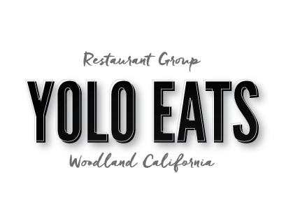 The logo for yolo eats restaurant group in woodland california