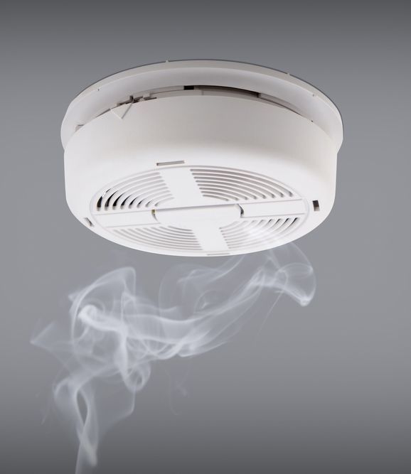Smoke Detector Installed On A Ceiling With Rising Smoke Underneath — Alert Smoke Alarm Compliance in Maryborough, QLD