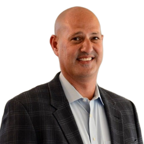A bald man in a suit and tie smiles for the camera