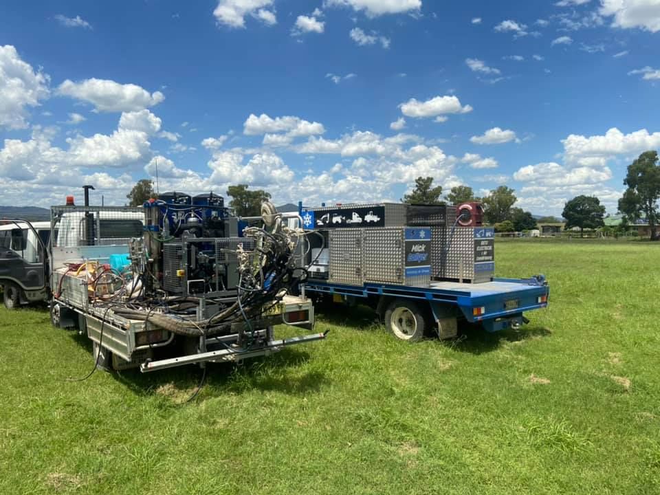 A Truck with a Trailer Attached to it is Parked in a Grassy Field — Auto Electrician Armidale