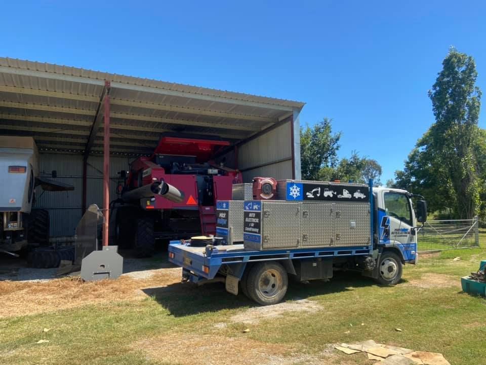A Truck is Parked in Front of a Shed with a Combine Harvester in it — Auto Electrician Quirindi