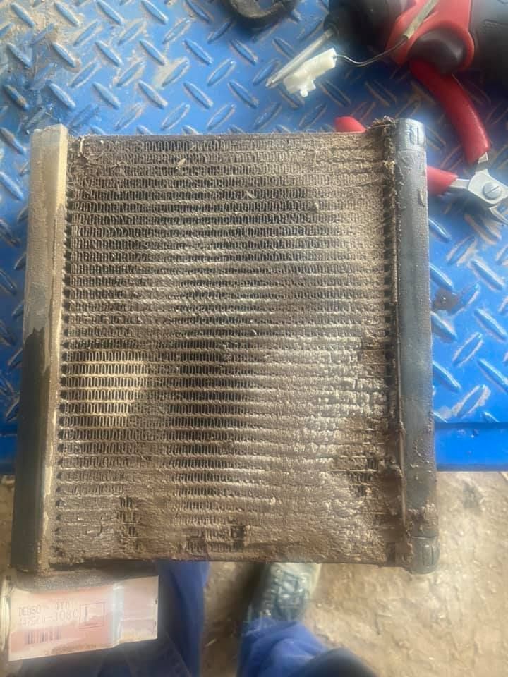 Dirty Car Radiator on a Blue Surface With A Stripper — Auto Electrician Gunnedah