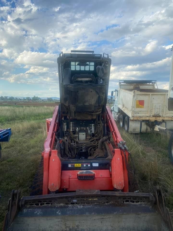 A Bulldozer is Parked in a Field with its Hood up — Auto Electrician Gunnedah