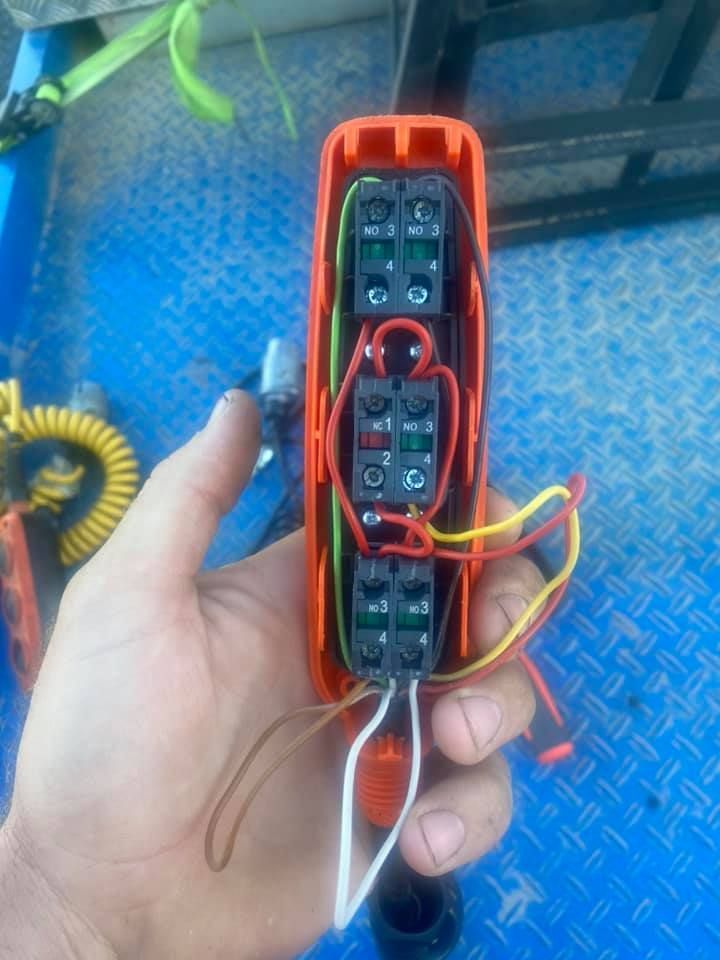 Hand holding Electrical Device with Wires Connected — Auto Electrician Tamworth