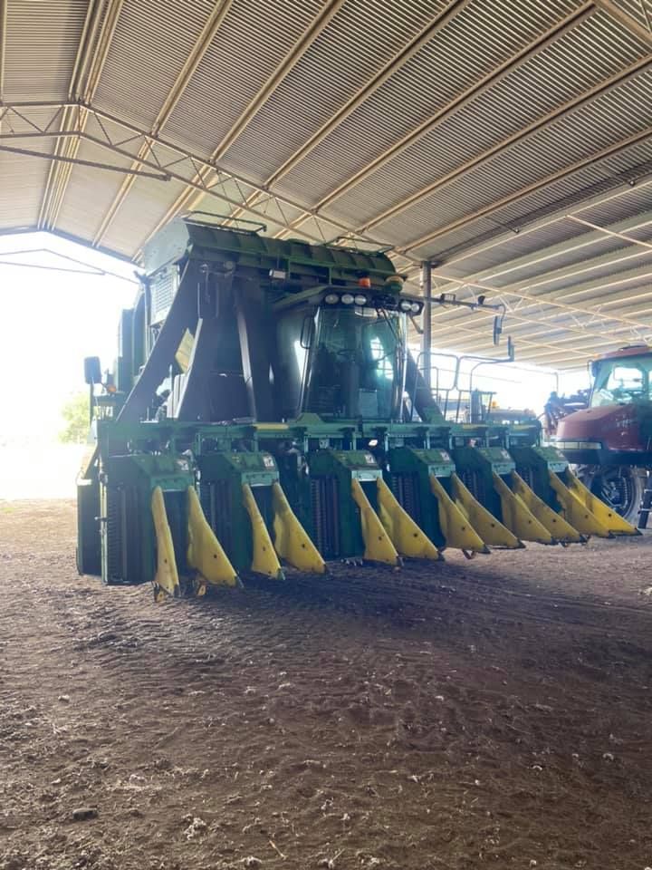A Large Green and Yellow Tractor is Parked in a Shed — Auto Electrician Tamworth