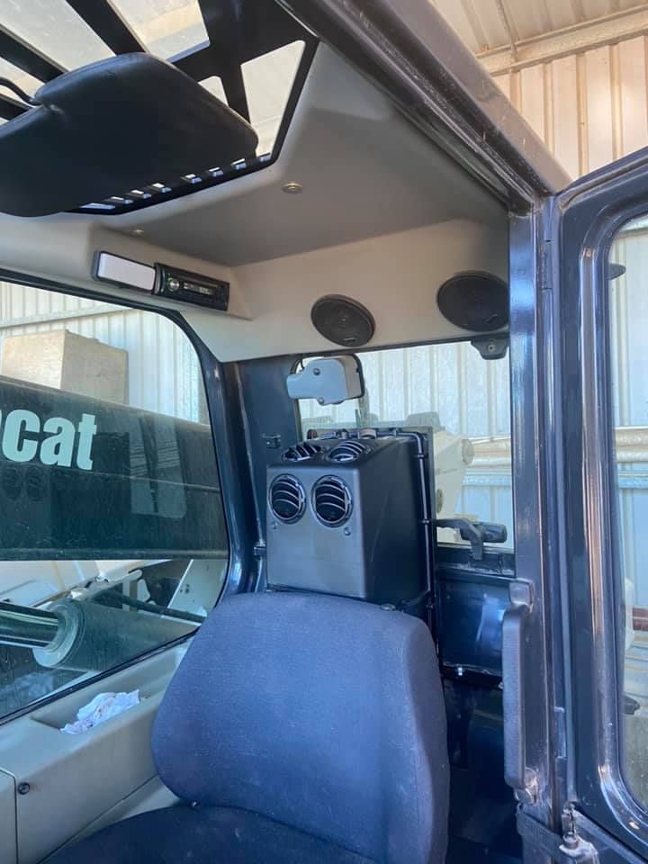 Inside view of a Vehicle with a Cat Logo on the Side — Auto Air Conditioning Repairs Tamworth