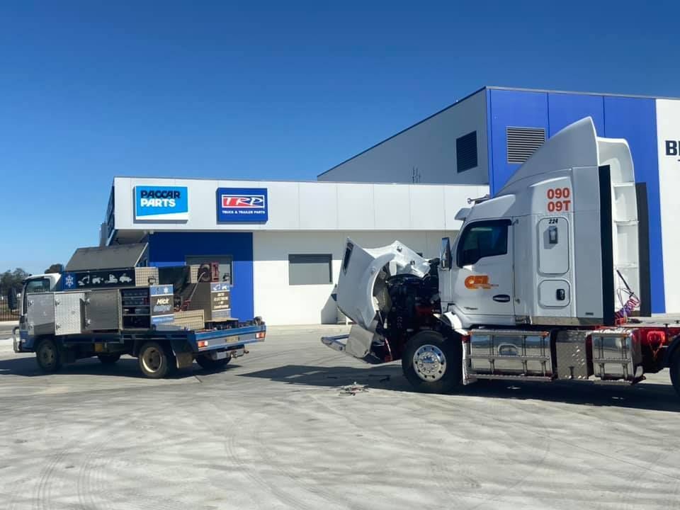 Two Trucks Parked Outside A Service Center — Auto Electrical Service Tamworth