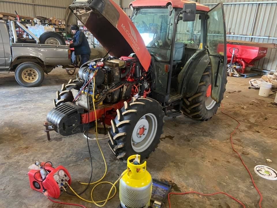 A Tractor is Being Worked on in a Garage with the Hood Up — Auto Electrical Service Tamworth