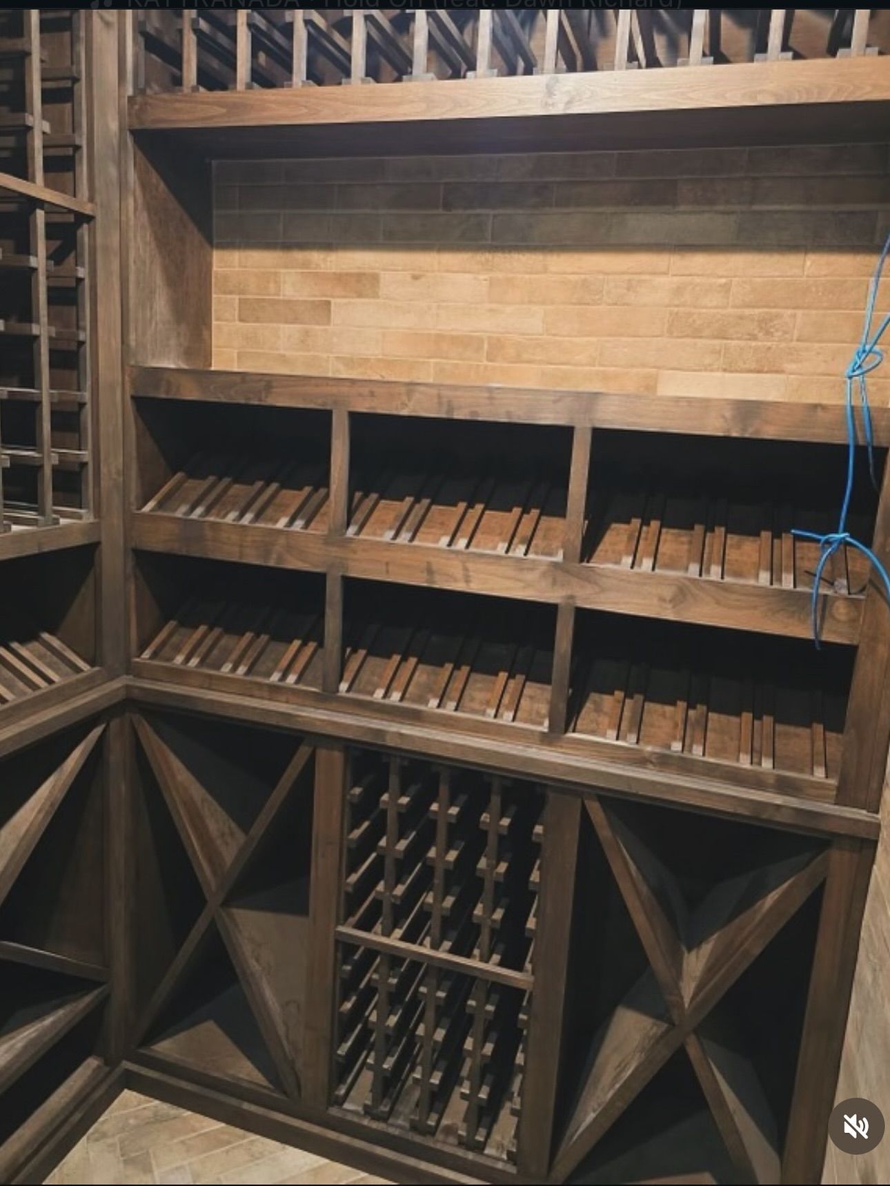 Wooden wine cellar with storage for wine bottles and cigars.