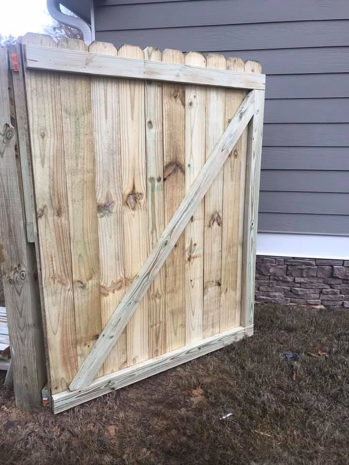 Wooden gate with diagonal support.