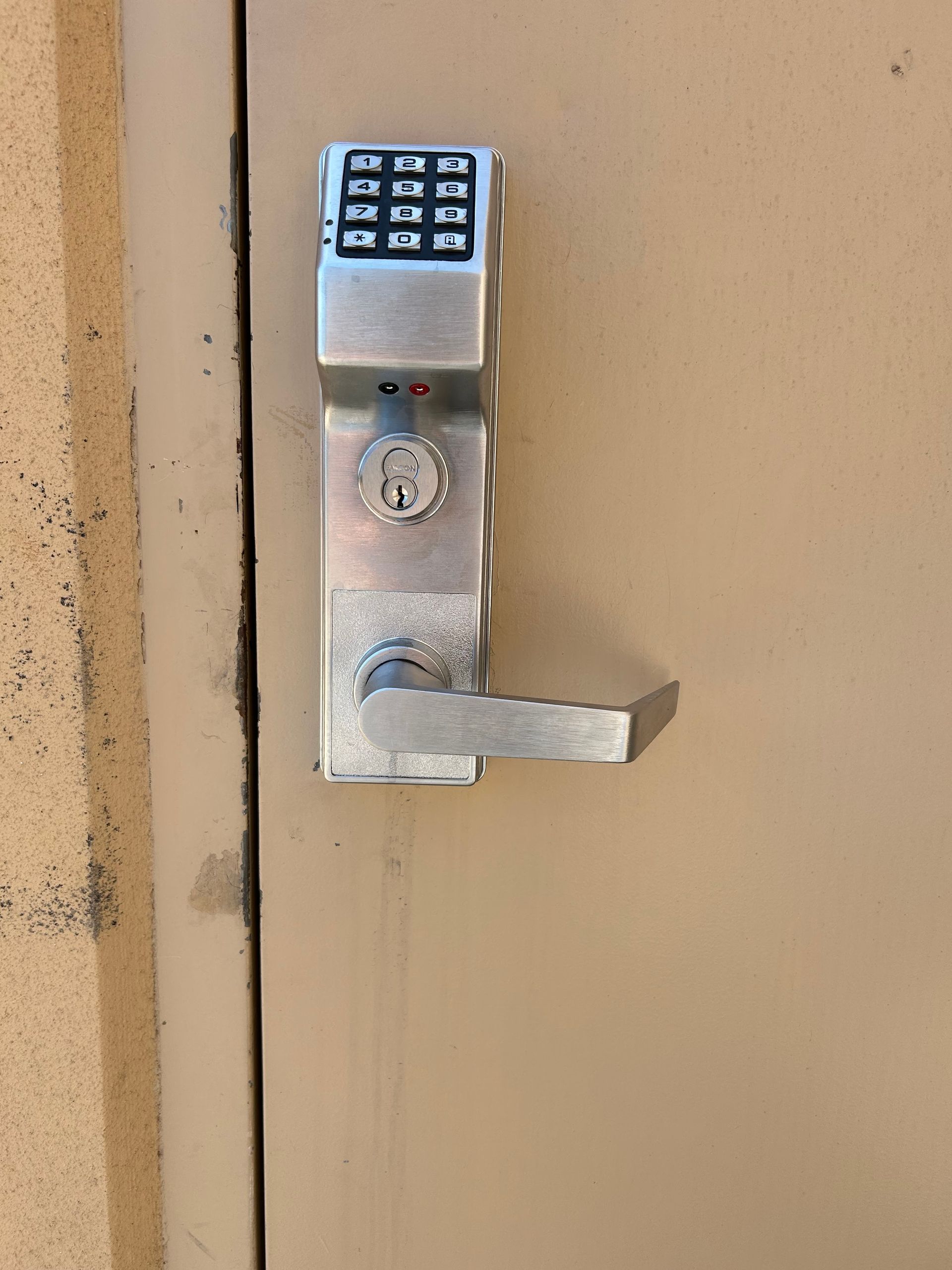 Metal door lock with keypad and lever handle.