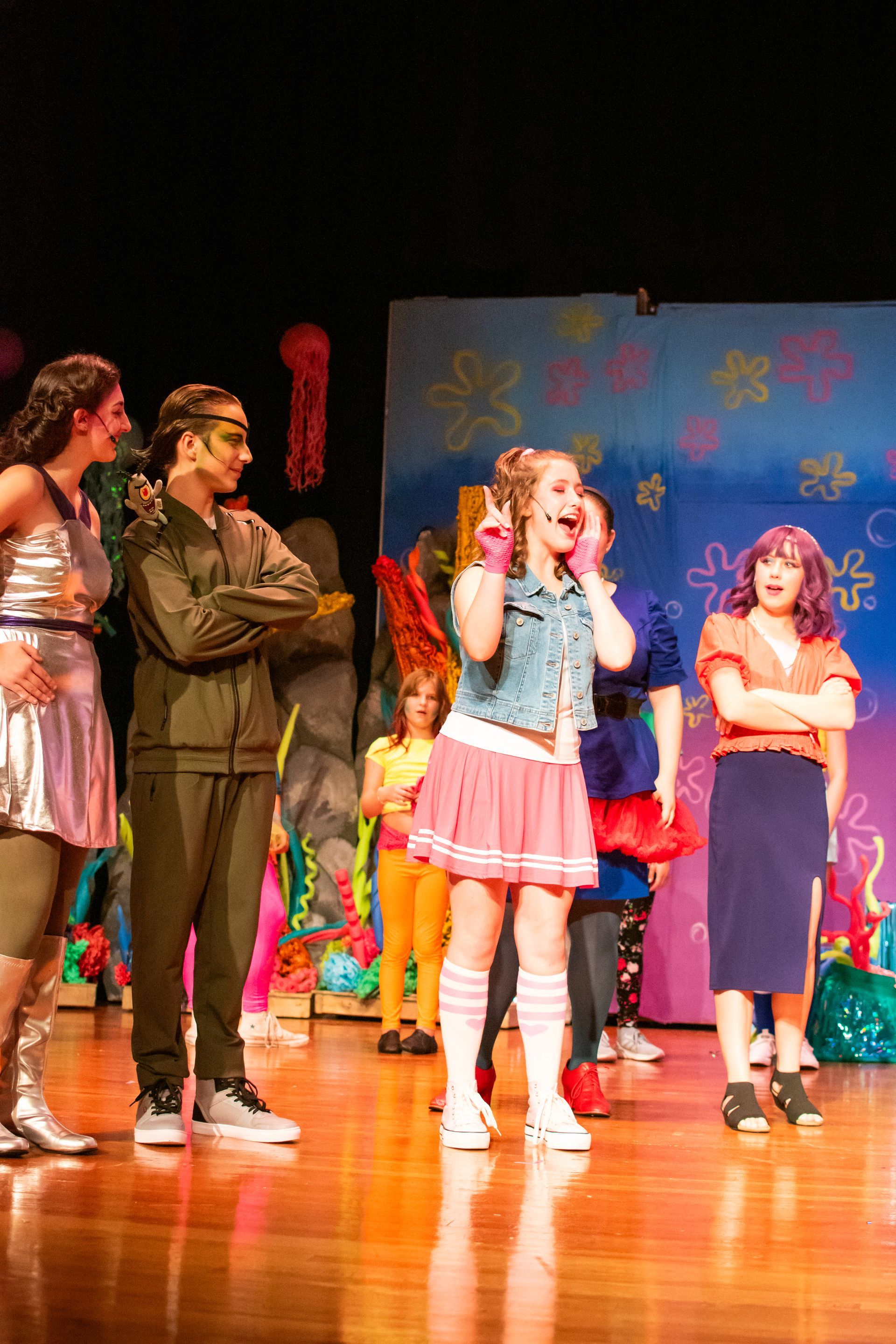 A stage production of SpongeBob SquarePants with actors in colorful costumes.