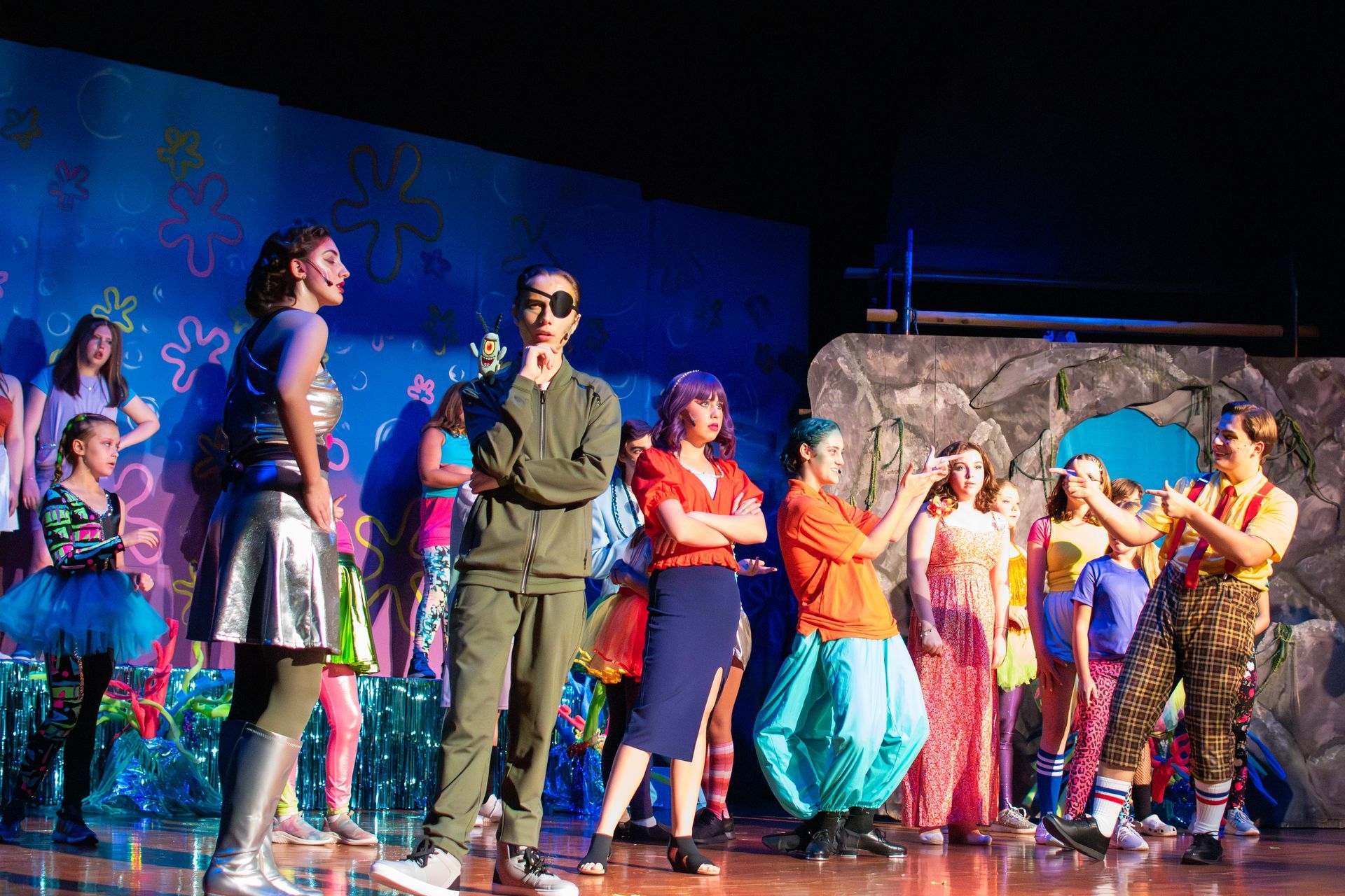 Spongebob musical stage with cast members. Characters in costumes, set background of the underwater world.