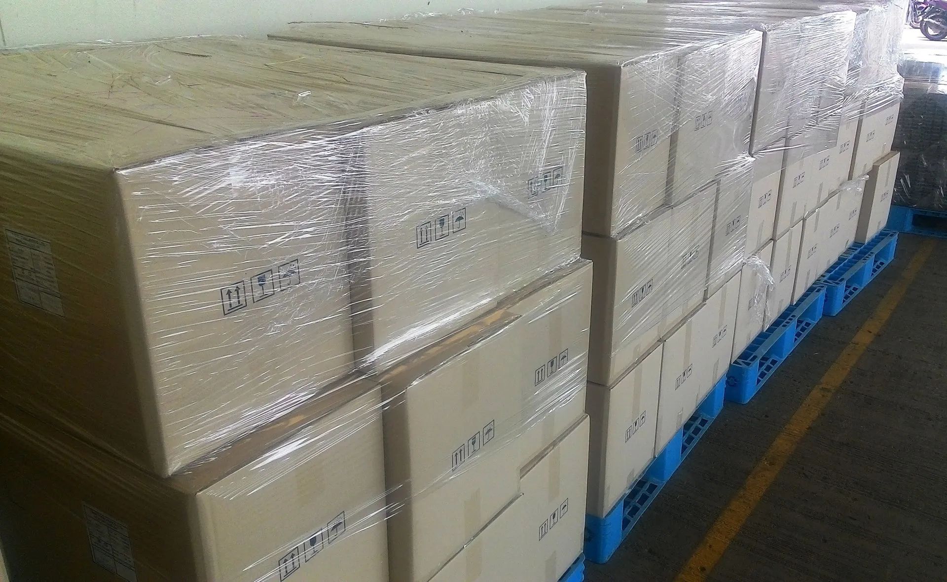 A warehouse filled with lots of boxes wrapped in plastic