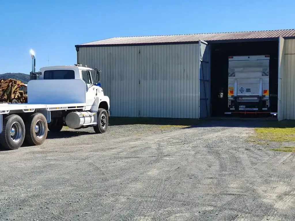 A truck with a flat bed is parked in front of a building. — Geisler Truck & Trailer Wheel Alignments In Pleystowe, QLD