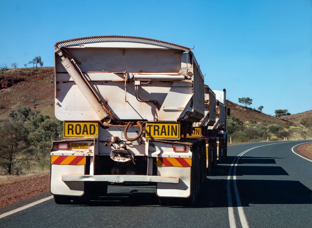 A Truck With A Sign On The Back That Says Road Train — Geisler Truck & Trailer Wheel Alignments In Marian, QLD