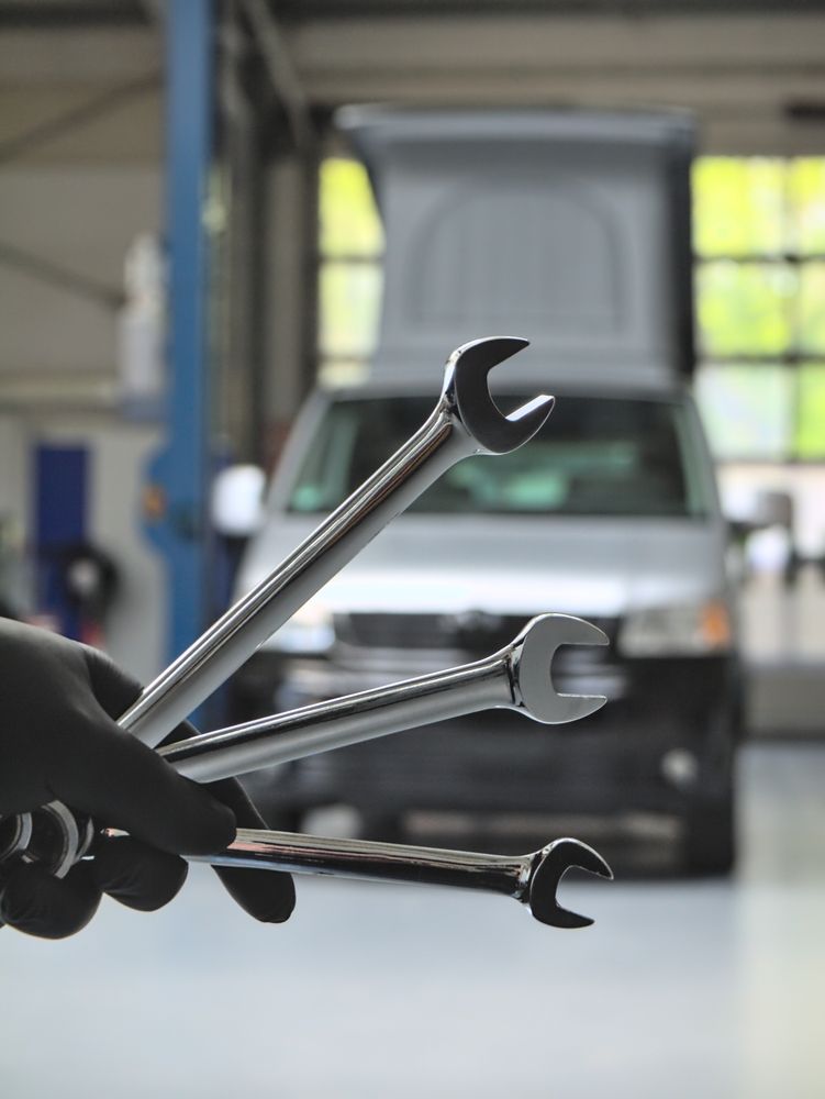 A Person Is Holding A Bunch Of Wrenches In Front Of A Car — Geisler Truck & Trailer Wheel Alignments In Pleystowe, QLD