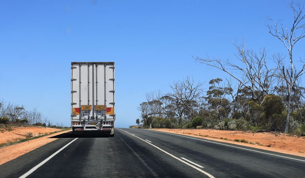 A Semi Truck Is Driving Down A Highway — Geisler Truck & Trailer Wheel Alignments In Pleystowe, QLD