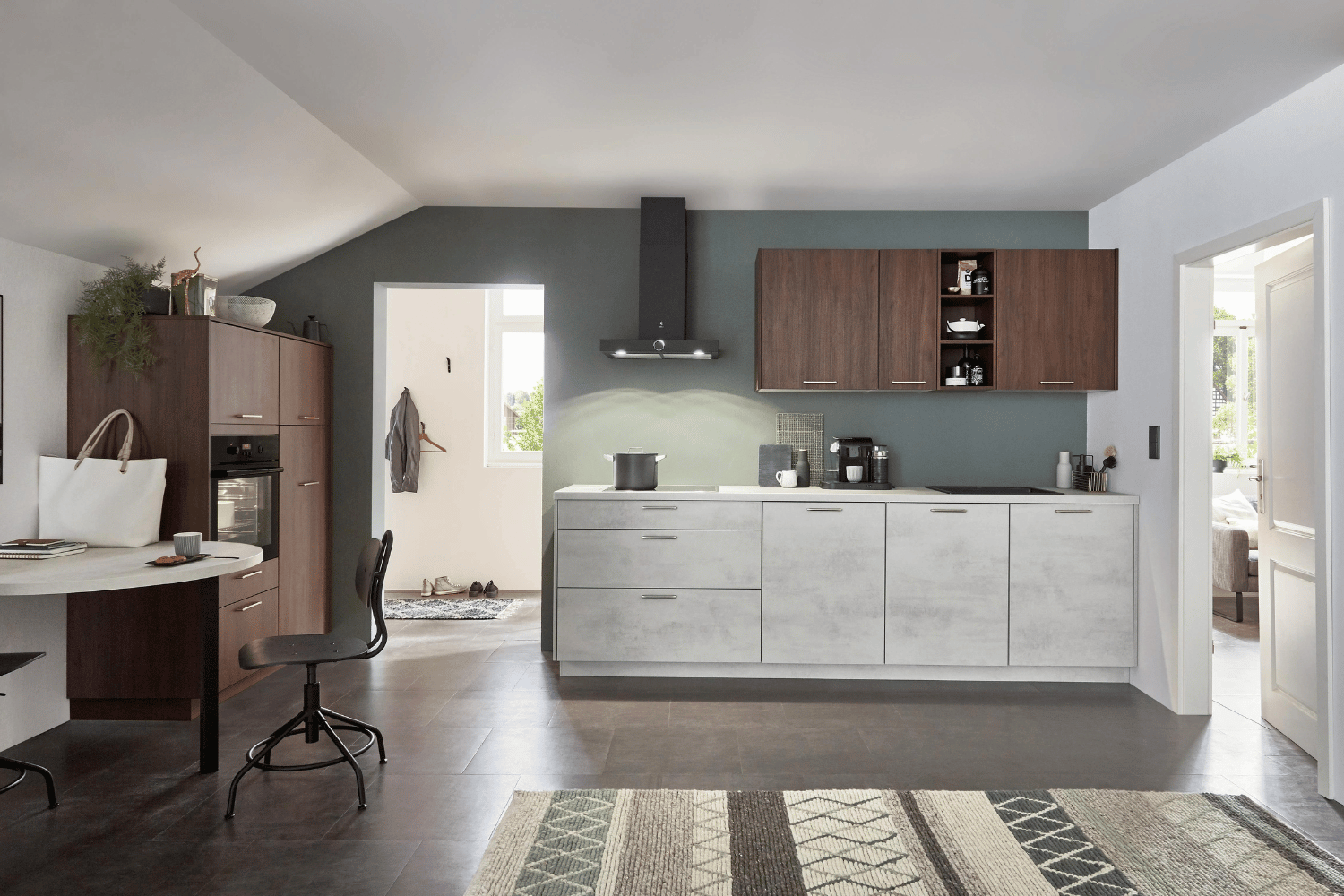 A modern white house with a black garage door and a car parked in front of it.