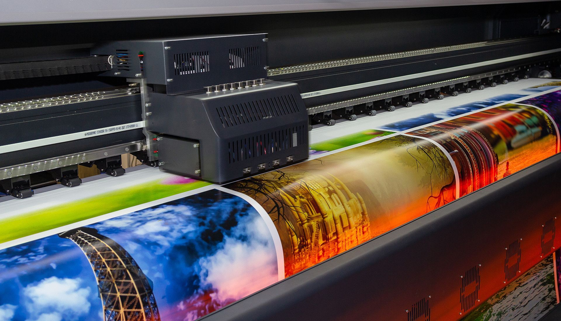 Open-concept living space with sectional sofa, kitchen, stairs, and ceiling fan.