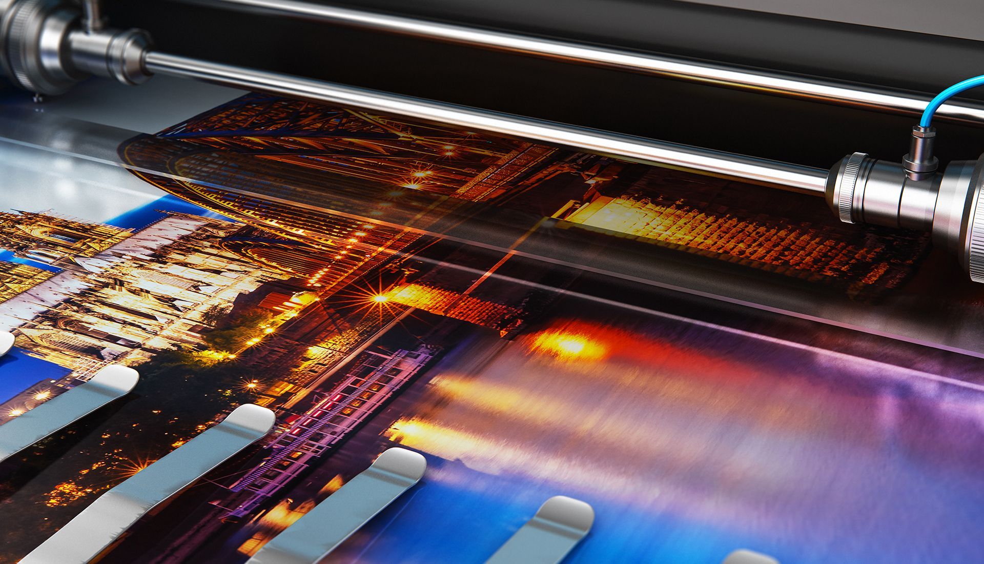 A printing machine applying a coating to a glossy photograph depicting a cityscape at night.