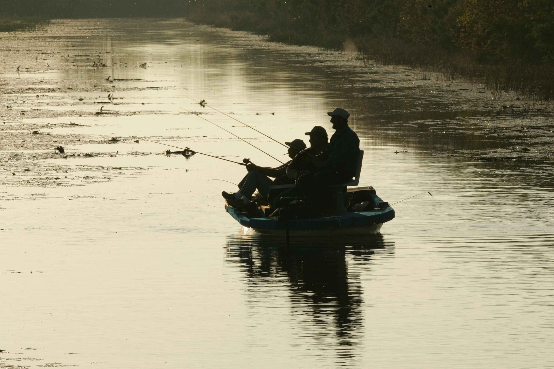 men fishing in small boat