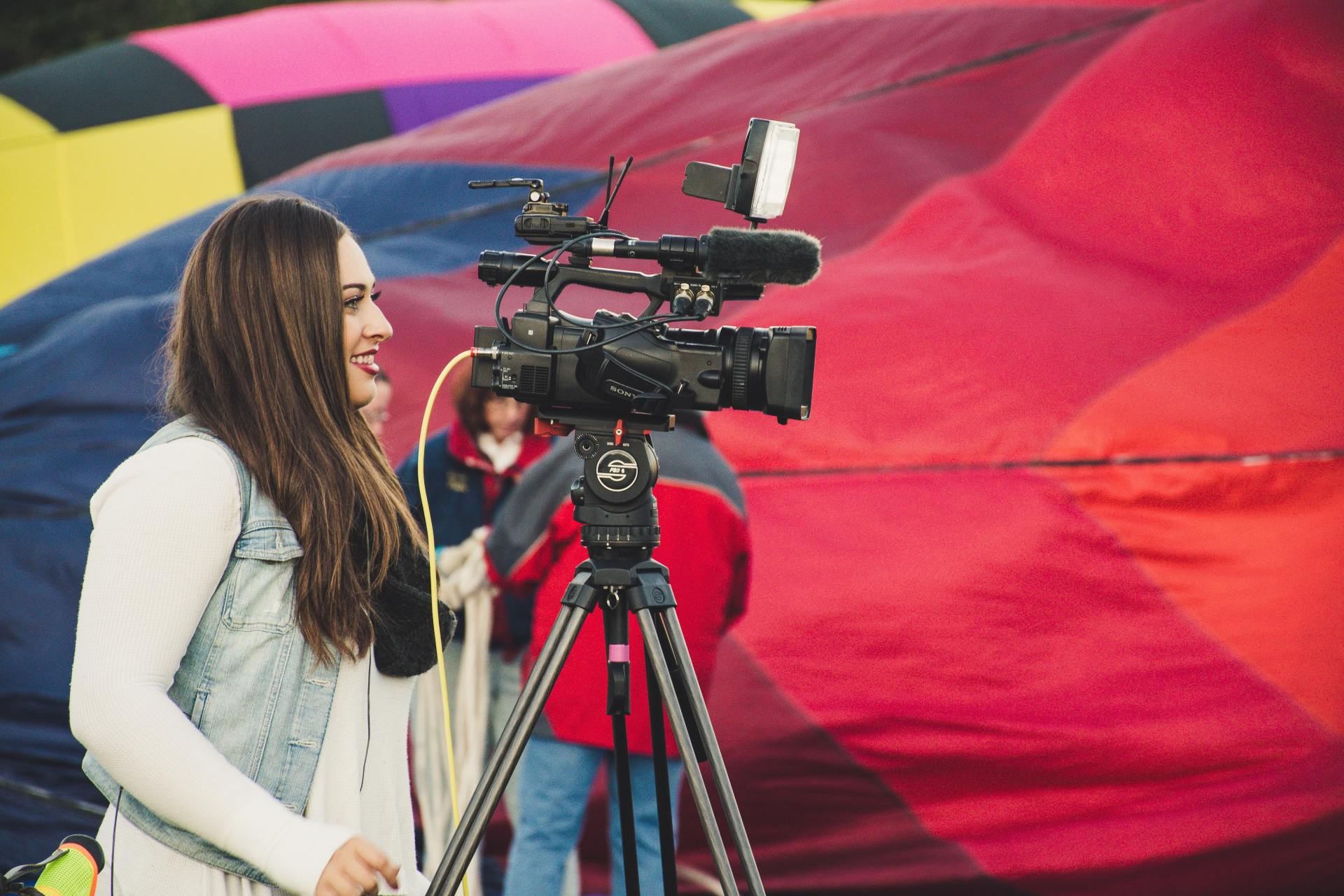 girl holding a camera making a video