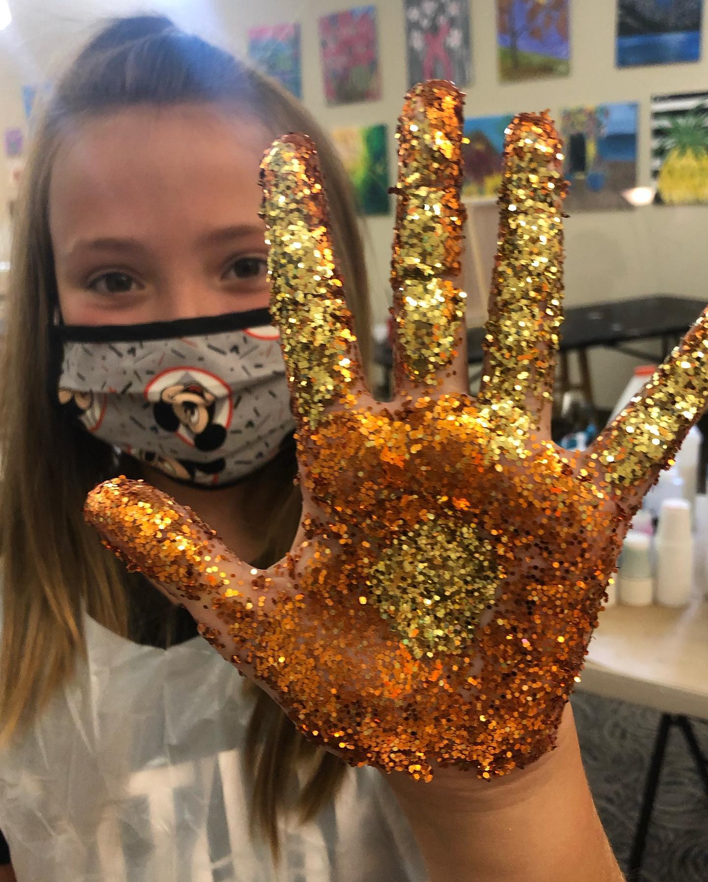 girl with golden glitter hand
