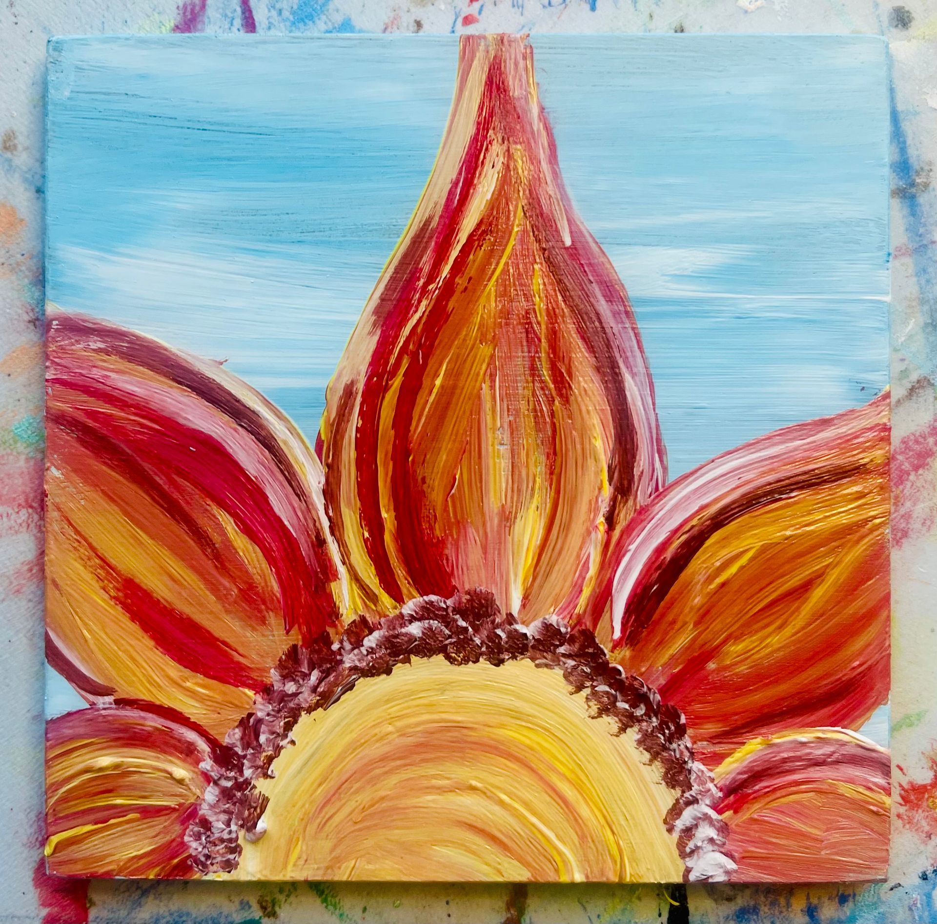 A painting of a sunflower with a blue sky in the background