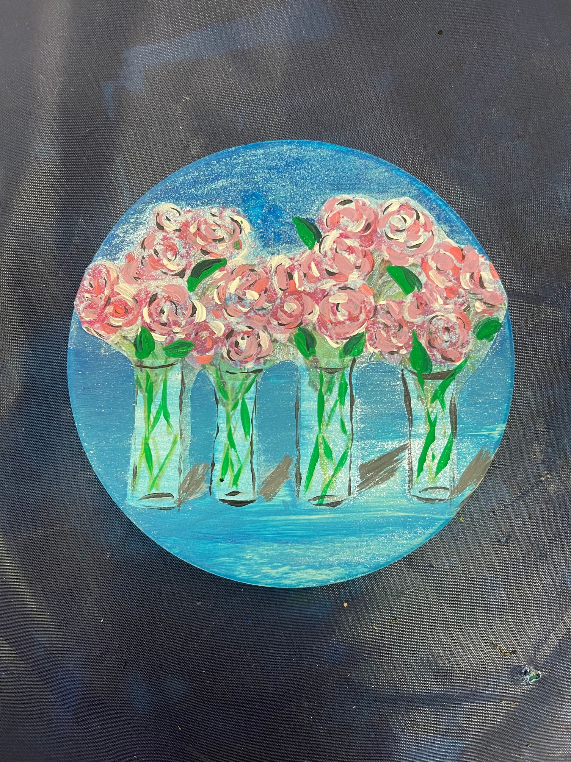 A painting of pink flowers in vases on a blue background
