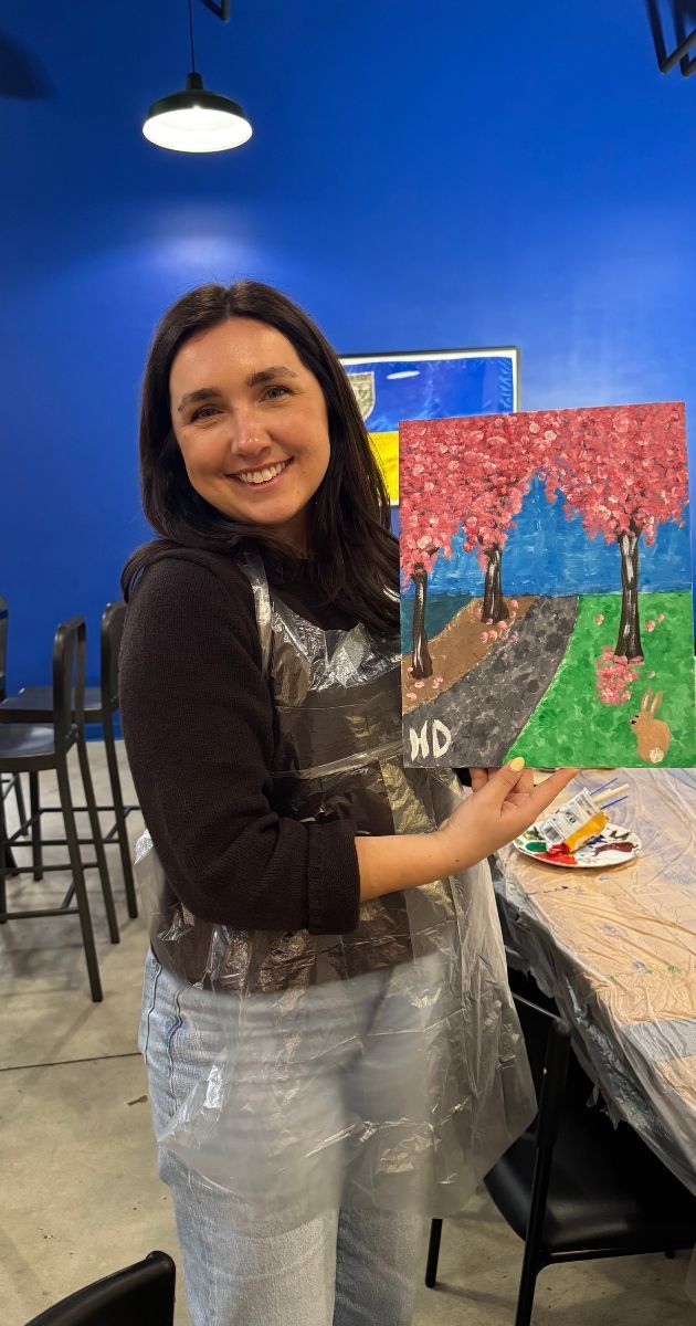 Group holding painted wood signs