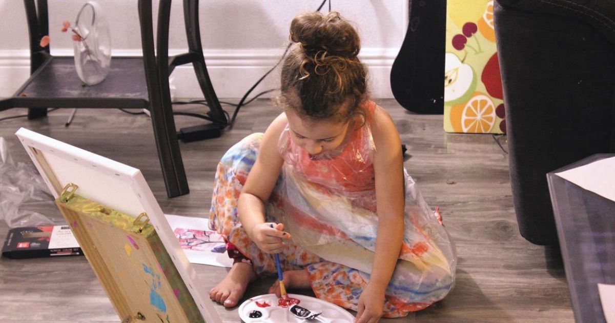 girls showing their paint-at-home art